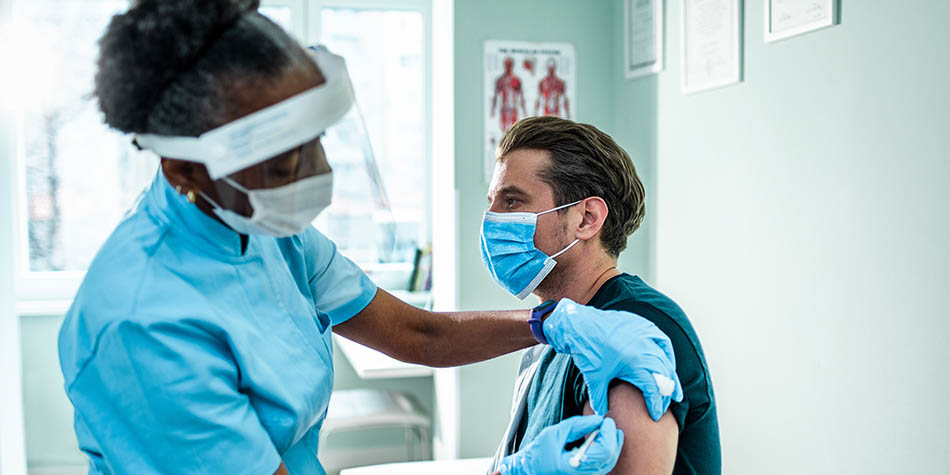 Close up of a young man getting flu shot